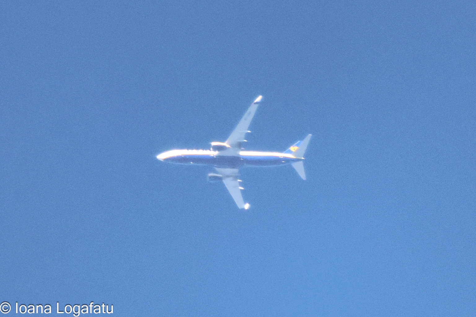 Airliner gliding through a clear blue sky